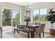 Dining room featuring a large table, ample seating, and sliding doors leading to an outdoor deck at 7778 Windwood Way, Parker, CO 80134