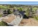Stunning two-story home with a three-car garage and professionally designed concrete driveway and lush green landscaping at 7778 Windwood Way, Parker, CO 80134