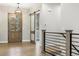 The foyer features wood flooring, with a front door, a sliding door, and a railing leading to the stairs at 7778 Windwood Way, Parker, CO 80134