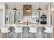 Modern kitchen with sleek countertops, stainless steel appliances, ample storage, and island seating at 7778 Windwood Way, Parker, CO 80134