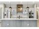 This kitchen features an island with pendant lights, sleek appliances, and white subway tile backsplash at 7778 Windwood Way, Parker, CO 80134