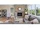 Cozy living room with brick fireplace, comfortable seating, and large windows offering great outdoor views at 7778 Windwood Way, Parker, CO 80134