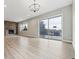 Expansive living room features brick fireplace, hardwood floors, large windows, and sliding doors at 7778 Windwood Way, Parker, CO 80134