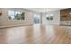 Spacious living room with hardwood floors, large windows, and an island with bar stool seating at 7778 Windwood Way, Parker, CO 80134