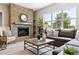 Cozy living room featuring a brick fireplace and large windows offering scenic views at 7778 Windwood Way, Parker, CO 80134