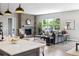 Open living room featuring a brick fireplace, comfortable seating, and a kitchen island at 7778 Windwood Way, Parker, CO 80134
