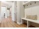 This mud room offers a built-in bench, hooks, and white accents at 7778 Windwood Way, Parker, CO 80134