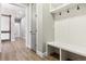 Mudroom features custom built-ins, wood floors, and access to additional rooms in the home at 7778 Windwood Way, Parker, CO 80134