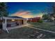 Backyard with patio, grill and storage, complemented by green grass and an additional building at 109 S Fulton Ave, Fort Lupton, CO 80621