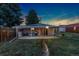 Well-maintained backyard featuring a covered patio, a grill, and ample green space, great for outdoor activities at 109 S Fulton Ave, Fort Lupton, CO 80621