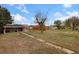Spacious backyard with a walkway leading to a covered patio at 109 S Fulton Ave, Fort Lupton, CO 80621