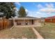 Home's backyard with a covered patio and a mix of grass and bare ground at 109 S Fulton Ave, Fort Lupton, CO 80621