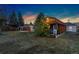 Large backyard with covered patio, accessory building, and lush greenery, ideal for entertaining and relaxation at 109 S Fulton Ave, Fort Lupton, CO 80621