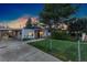 Charming home featuring a well-manicured lawn, fenced yard, covered carport, and inviting front entrance at 109 S Fulton Ave, Fort Lupton, CO 80621