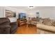 Cozy living room with comfortable seating, wood floors, and bright natural light at 109 S Fulton Ave, Fort Lupton, CO 80621