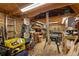 Well-lit workshop with wooden beams, storage, and various tools at 109 S Fulton Ave, Fort Lupton, CO 80621