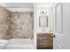 Updated bathroom with modern vanity, shower, and tiled walls at 6880 W Airview Ave, Lakewood, CO 80232