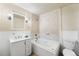 Bathroom with a large soaking tub and white cabinetry at 6880 W Airview Ave, Lakewood, CO 80232