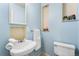 Light blue bathroom with pedestal sink, toilet and built-in shelves at 6880 W Airview Ave, Lakewood, CO 80232