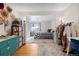 Inviting bedroom space with wood floors and view to additional room and large dresser at 6880 W Airview Ave, Lakewood, CO 80232