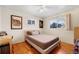 Cozy bedroom with a bed, two windows and a wooden floor at 6880 W Airview Ave, Lakewood, CO 80232