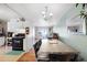 Open concept dining room with modern chandelier, and view to kitchen at 6880 W Airview Ave, Lakewood, CO 80232