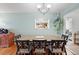 Inviting dining room with a wooden table, six chairs, and a hanging plant for a touch of nature at 6880 W Airview Ave, Lakewood, CO 80232
