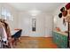 Dressing room featuring hats, turquoise dresser, hardwood floors and large mirror at 6880 W Airview Ave, Lakewood, CO 80232