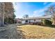 Charming single-story home with a covered carport and a well-maintained front yard under a bright sky at 6880 W Airview Ave, Lakewood, CO 80232