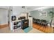 Open concept kitchen with black oven, cart and view to dining area at 6880 W Airview Ave, Lakewood, CO 80232