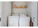 Laundry room with a white washer and dryer and shelving above at 6880 W Airview Ave, Lakewood, CO 80232