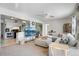 Bright and airy living room showcasing a comfy sectional couch, ceiling fan, and television at 6880 W Airview Ave, Lakewood, CO 80232