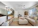 Bright living room with a comfortable sectional sofa, ceiling fan, and large windows for natural light at 6880 W Airview Ave, Lakewood, CO 80232