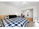 Spacious main bedroom featuring a Buffalo plaid bedspread, and view to additional room at 6880 W Airview Ave, Lakewood, CO 80232