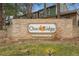 Otero Ridge community entrance sign set in a decorative brick wall with landscaping at 2670 E Otero Pl # 11, Centennial, CO 80122