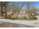 Otero Ridge community entrance sign with mature trees, bushes and lush green landscaping at 2670 E Otero Pl # 11, Centennial, CO 80122