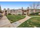 View of condo complex showing lawn and walkway to building entrance at 2670 E Otero Pl # 11, Centennial, CO 80122