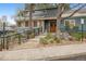 Inviting exterior entrance with wood door, metal railings and stone details for enhanced curb appeal at 2670 E Otero Pl # 11, Centennial, CO 80122