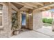 Unit 11 entryway features brick walls, an open front door, and a blue interior wall at 2670 E Otero Pl # 11, Centennial, CO 80122