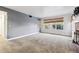 Spacious living room with neutral carpet, gray walls, and a large window at 2670 E Otero Pl # 11, Centennial, CO 80122