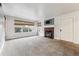 Bright living room with neutral carpet, brick fireplace, and large windows at 2670 E Otero Pl # 11, Centennial, CO 80122