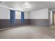 Neutral colored basement with blue curtains and paneling at 416 Pluto Ct, Lone Tree, CO 80124