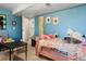 Bedroom with blue walls and floral bedding at 416 Pluto Ct, Lone Tree, CO 80124