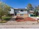 Charming two-story home with blue siding, solar panels, well-maintained landscaping and a two car garage at 416 Pluto Ct, Lone Tree, CO 80124