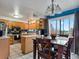 Bright eat-in kitchen featuring wood cabinets, tile flooring, and sliding glass doors leading to an outdoor area at 416 Pluto Ct, Lone Tree, CO 80124