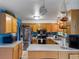 Functional kitchen featuring stainless steel appliances, wood cabinets, and a breakfast bar at 416 Pluto Ct, Lone Tree, CO 80124