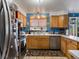 Functional kitchen with stainless steel appliances, wood cabinets, and ample counter space at 416 Pluto Ct, Lone Tree, CO 80124