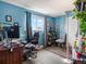 Home office featuring blue walls, a computer desk, a gaming chair, and a window at 416 Pluto Ct, Lone Tree, CO 80124