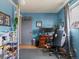 Home office featuring blue walls, a computer desk, a gaming chair, and a window at 416 Pluto Ct, Lone Tree, CO 80124