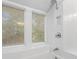 Bright bathroom features a tiled shower with large windows bringing the outdoors in at 23551 Genesee Village Rd # H, Golden, CO 80401